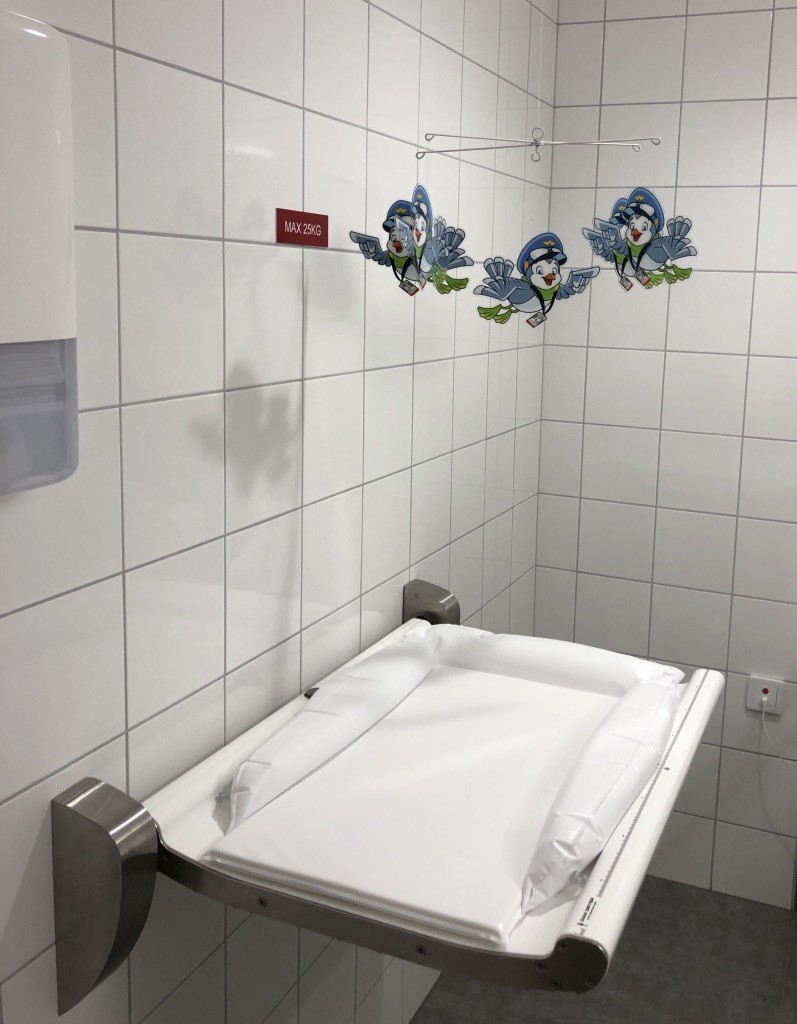 A photo of a diaper changing station at an airport in Sweden.